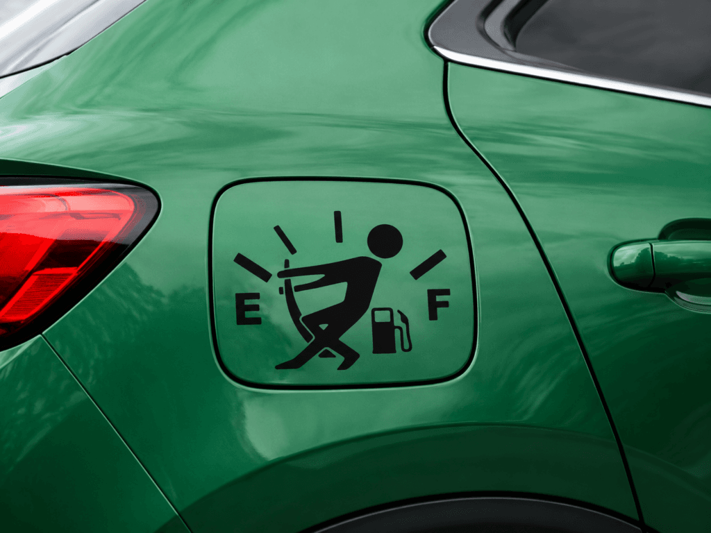 Sticker de plotter de corte negro aplicado sobre la tapa de combustible de un vehículo verde.